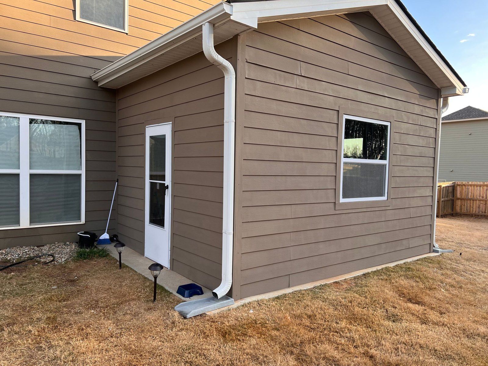 Completed home addition with new siding, windows and door