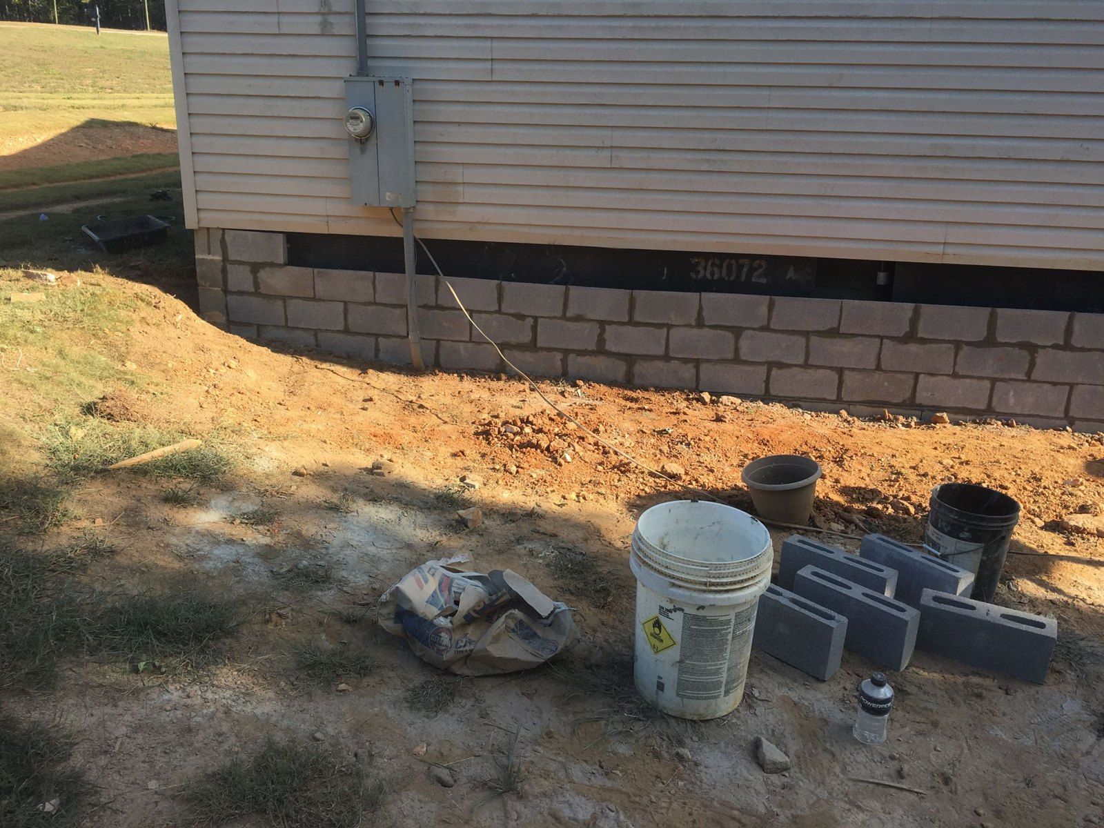 Block foundation work along the side of a home