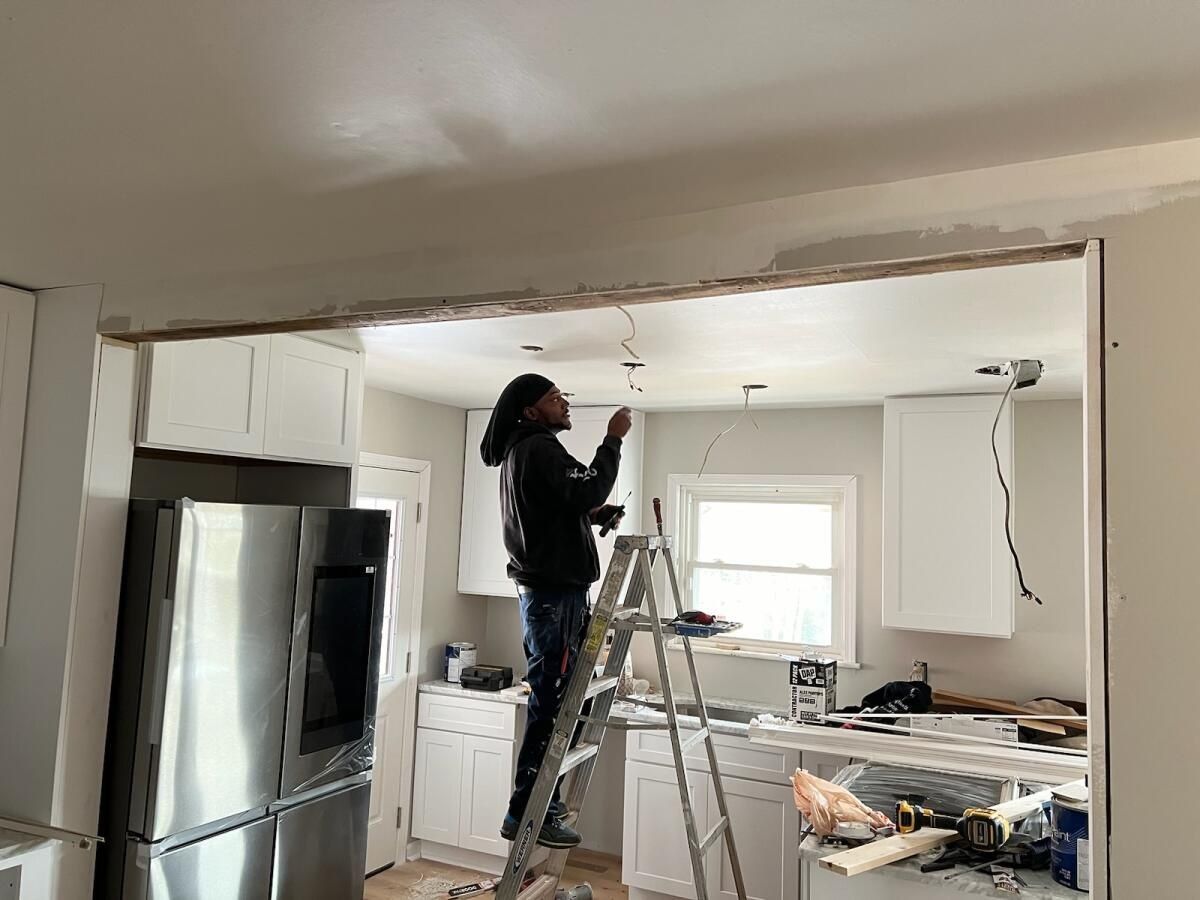 Kitchen renovation in progress with new white cabinetry